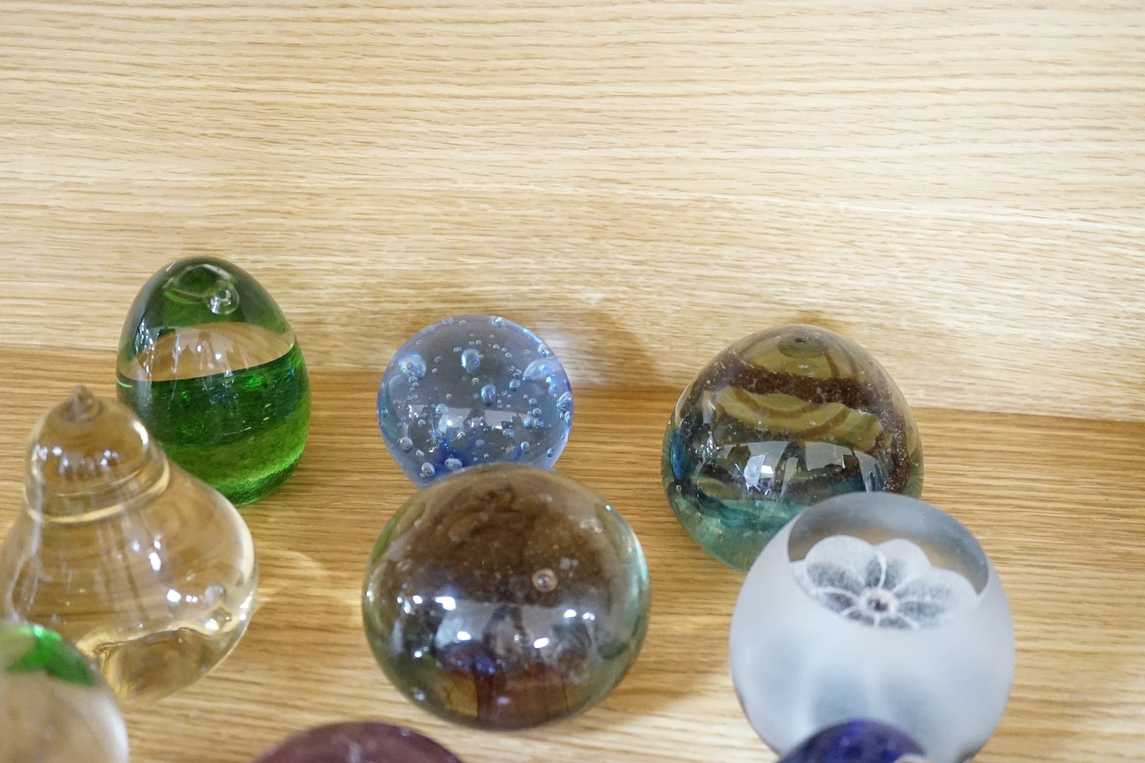A collection of mixed paperweights to include a faceted floral Perthshire example, other Scottish floral and millefiori examples (Qty), tallest 12cms high